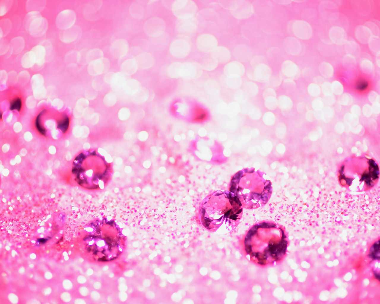A close up of some pink jewels on the ground