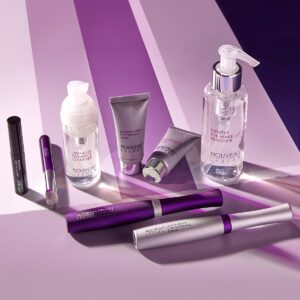 A purple and silver striped background with cosmetics.