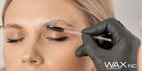 A woman getting her eyebrows tattooed